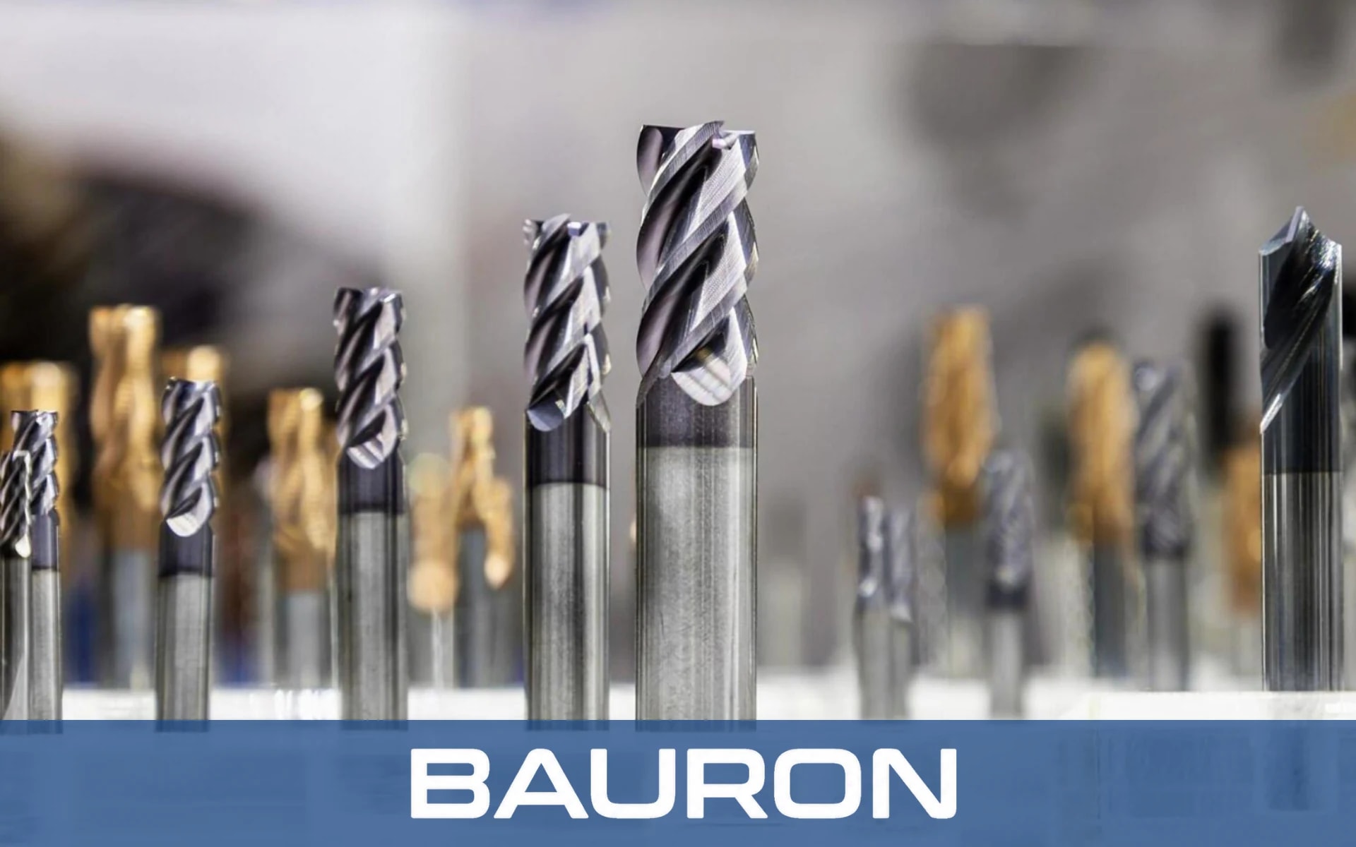 Coated carbide end mills and a drill lined up on a tooling display