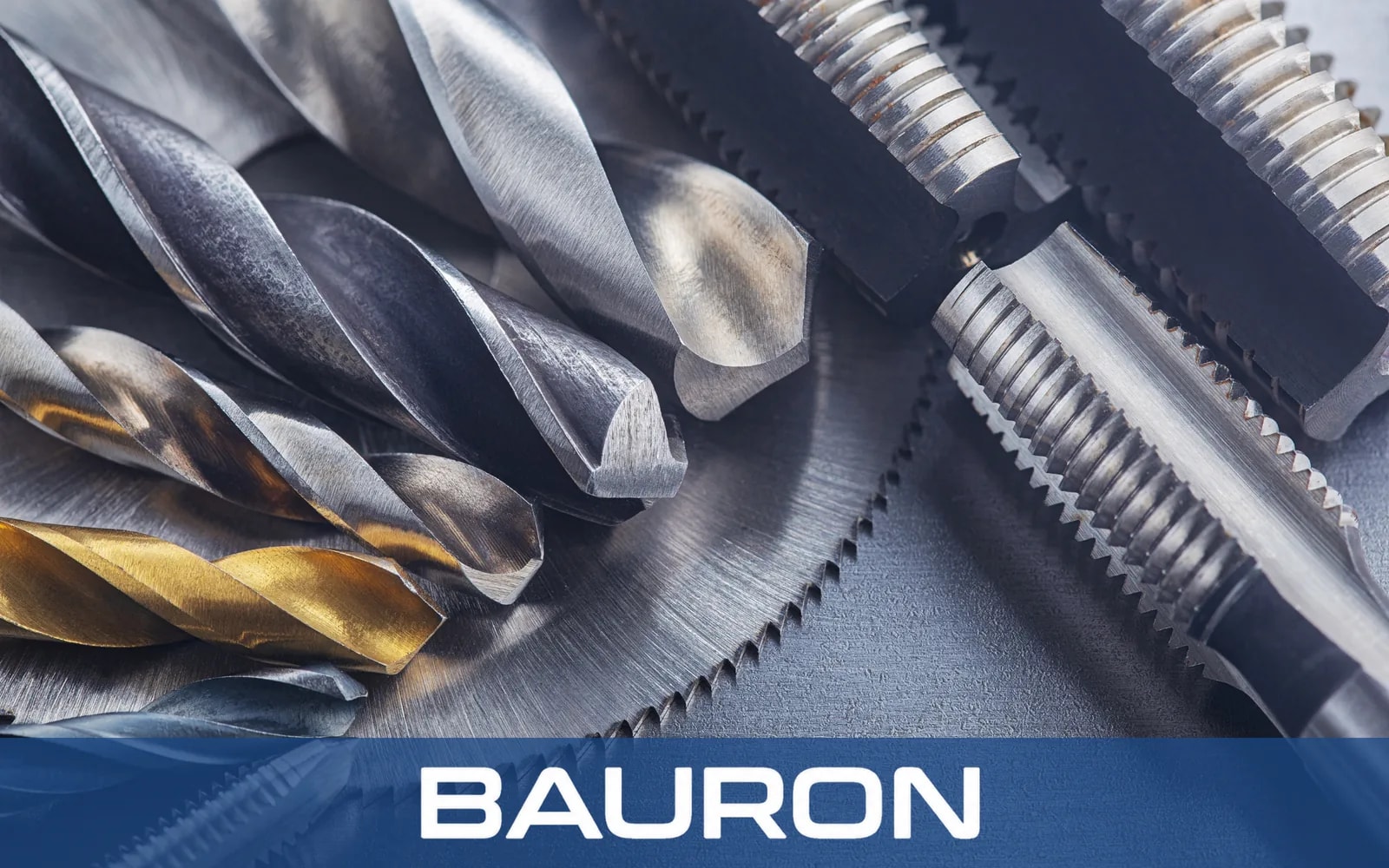 Coated drills and taps in close-up on a steel surface